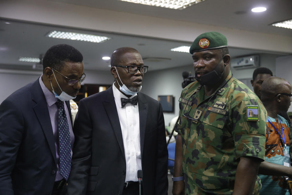 In this photo taken on Saturday Nov. 14, 2020. Brig. Gen. Ahmed Taiwo, Commander of the 81 Military Intelligence Brigade, right, speaks with lawyers before a judicial committee, in Lagos Nigeria. Nigeria's army has said after weeks of denial that its troop did fire shots into the air to disperse a large crowd at the Lekki Toll Plaza in Lagos where several peaceful protesters were killed late in October. (AP Photo/Sunday Alamba)