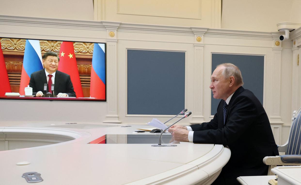 Russian president Vladimir Putin holds a meeting with Chinese president Xi Jinping via a video link at the Kremlin in Moscow on 30 December 2022 (AFP via Getty Images)