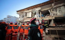 Rescuers search for people buried under the rubble on a collapsed building, after an earthquake struck Elazig, eastern Turkey, Saturday, Jan. 25, 2020. Emergency workers and security forces distributed tents, beds and blankets as overnight temperatures dropped below freezing in the affected areas. Mosques, schools, sports halls and student dormitories were opened for hundreds who left their homes after the quake. (IHH/ Humanitarian Relief Foundation via AP)