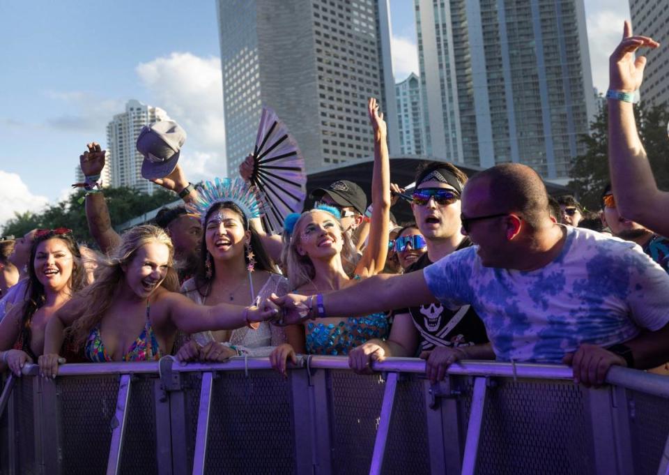 Two festivalgoers hold hands during Afrojack’s set at Ultra Day 3 at the Main Stage on Sunday, March 24, 2024, at Bayfront Park in downtown Miami.