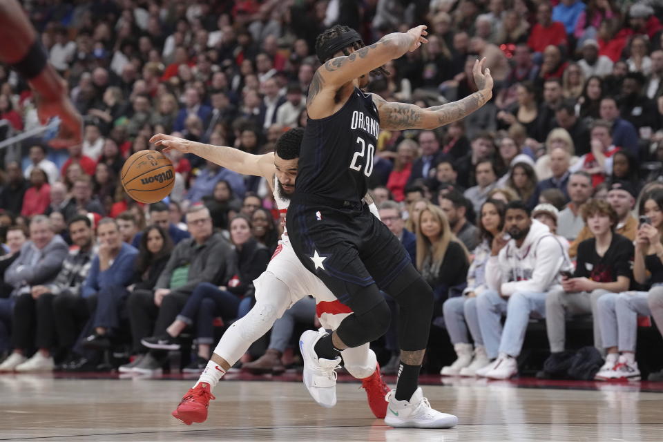 Toronto Raptors' Fred VanVleet drives past Orlando Magic's Markelle Fultz, right, during the first half of an NBA basketball game in Toronto on Tuesday, Feb. 14, 2023. (Chris Young/The Canadian Press via AP)