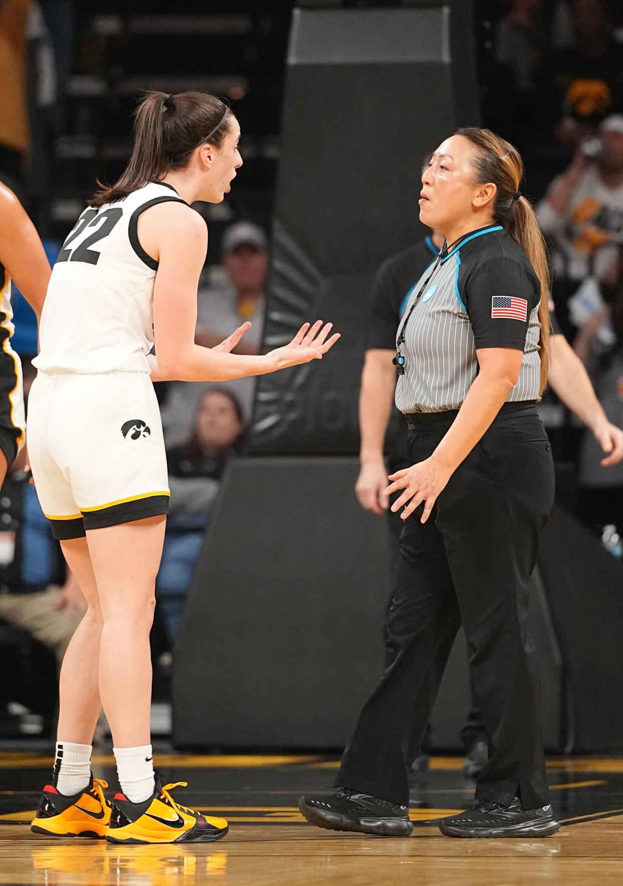 Caitlin Clark talks to an official in a second-round NCAA Tournament game between Iowa and West Virginia.