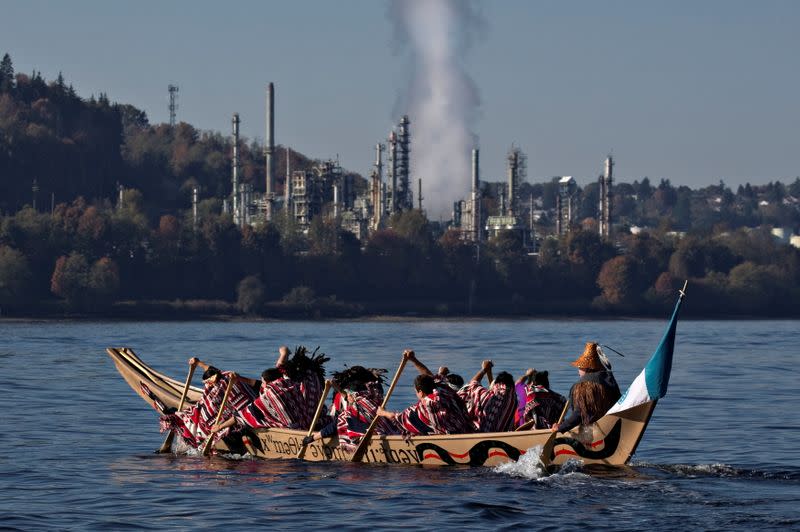 FILE PHOTO: First Nation Tsleil-Waututh, Squamish and Musqueam bands paddle in a canoe during a protest in North Vancouver