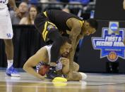 <p>Northern Kentucky forward Jeff Garrett (4), top, and Kentucky guard Isaiah Briscoe (13) fight for a loose ball during the second half of a first-round game in the men’s NCAA college basketball tournament in Indianapolis, Friday, March 17, 2017. Kentucky defeated Northern Kentucky 79-70. (AP Photo/Michael Conroy) </p>