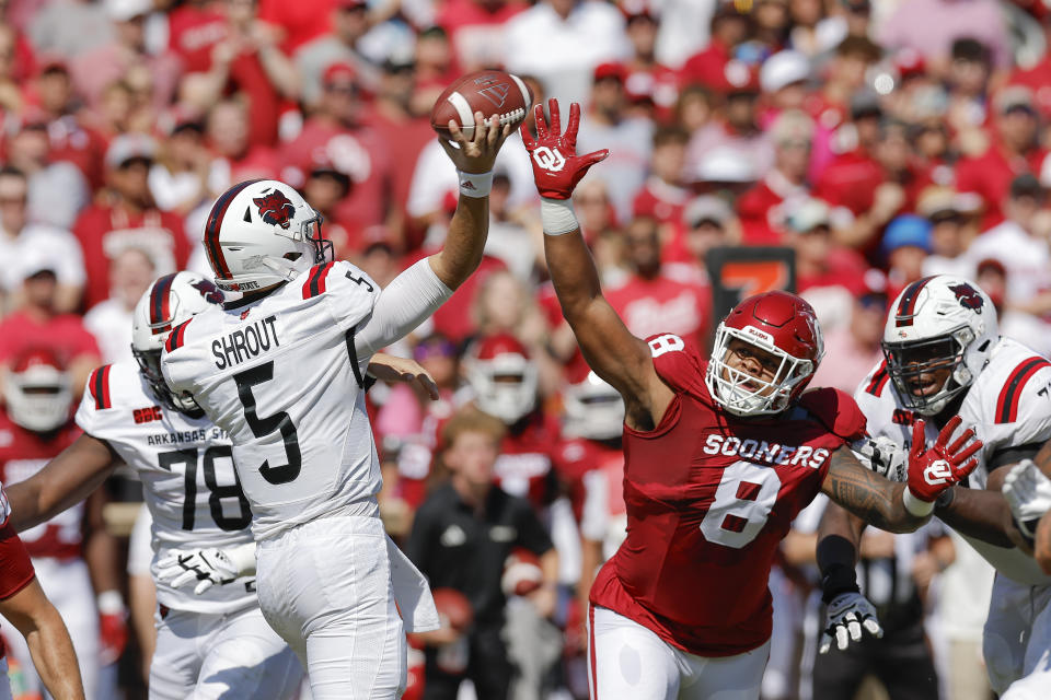 Oklahoma defensive lineman Jonah Laulu (8) applies pressure as Arkansas State quarterback J.T. Shrout (5) passes the ball during the first half of an NCAA college football game, Saturday, Sept. 2, 2023, in Norman, Okla. (AP Photo/Alonzo Adams)