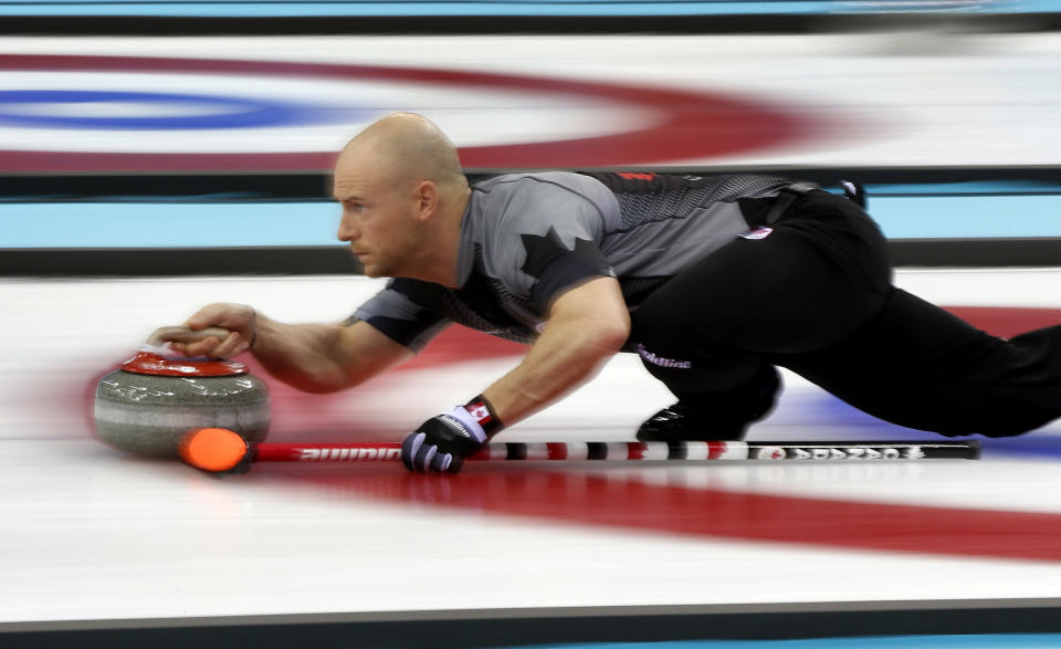 Canada's vice-skip Ryan Fry delivers the rock during men's curling competition against Denmark at the 2014 Winter Olympics, Thursday, Feb. 13, 2014, in Sochi, Russia.