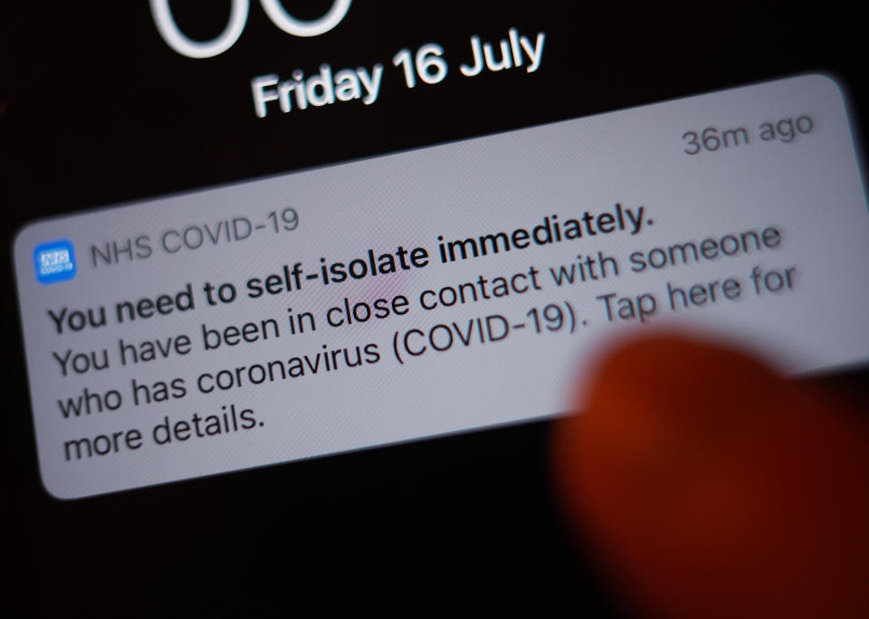A notification issued by the NHS coronavirus contact tracing app - informing a person of the need to self-isolate immediately, due to having been in close contact with someone who has coronavirus - is displayed on a mobile phone in London, during the easing of lockdown restrictions in England. Picture date: Friday July 16, 2021. (Photo by Yui Mok/PA Images via Getty Images)