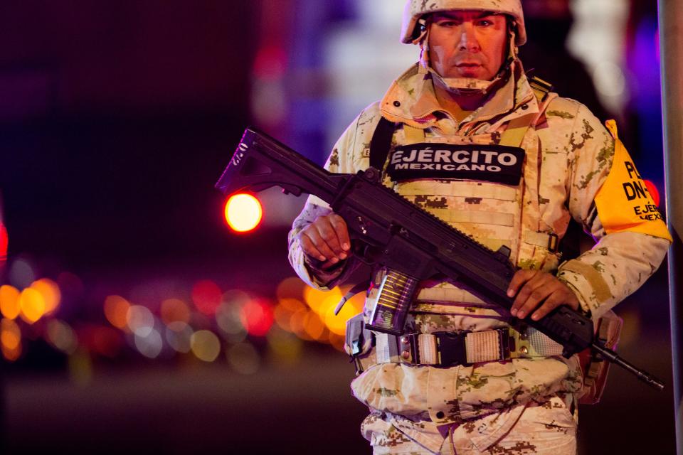 A Mexican army soldier guards the scene of a deadly fire at a Mexican immigration detention center in Juárez  on March 27.
