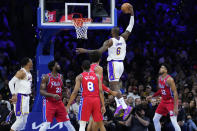 Los Angeles Lakers' LeBron James (6) goes up for a dunk during the first half of an NBA basketball game against the Philadelphia 76ers, Friday, Dec. 9, 2022, in Philadelphia. (AP Photo/Matt Slocum)