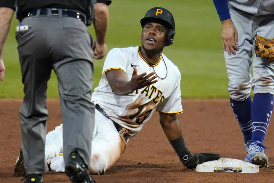 Pittsburgh Pirates' Ke'Bryan Hayes (13) appeals to umpire Dan Iassogna, left, after sliding past second base and being tagged out by Los Angeles Dodgers second baseman Chris Taylor during the third inning of a baseball game in Pittsburgh, Tuesday, June 8, 2021. Hayes remained out and the inning ended. (AP Photo/Gene J. Puskar)