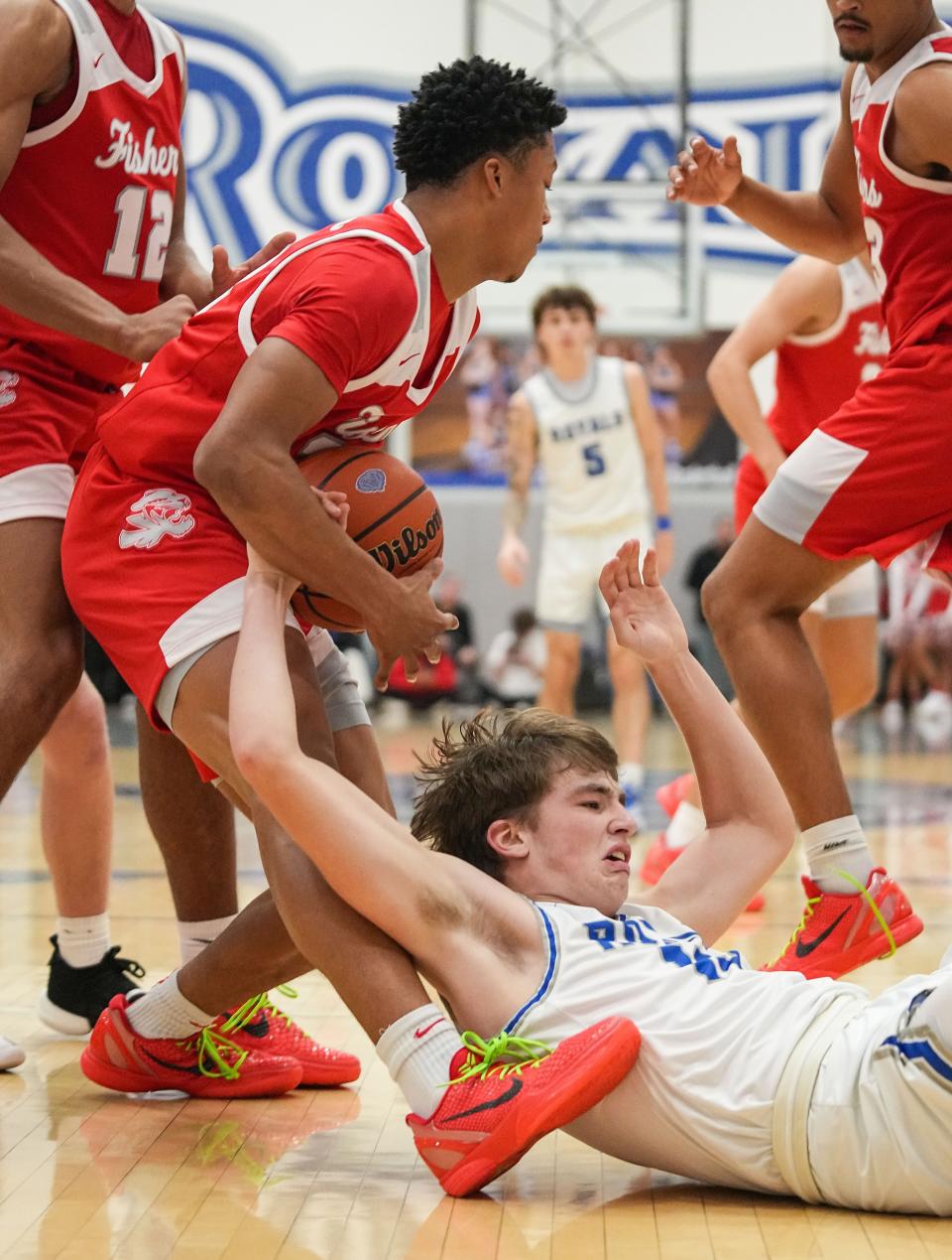 Hamilton Southeastern Royals Braeden Totton (13) loses control of the ball against Fishers Tigers guard JonAnthony Hall (22) on Friday, Dec. 15, 2023, during the game at Hamilton Southeastern High School in Fishers. The Fishers Tigers defeated the Hamilton Southeastern Royals, 64-57.