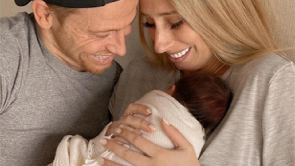 Stacey Solomon poses with husband Joe Swash and baby Belle