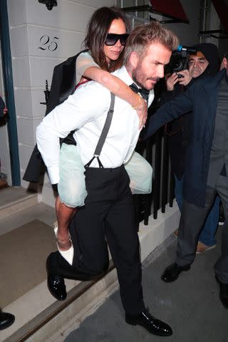 <p>Ricky Vigil M / Justin E Palmer/GC Images</p> David Beckham carries Victoria Beckham from her 50th birthday party on April 20, 2024, in London