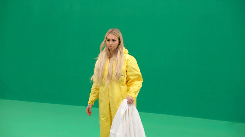 "Bachelor" star Corinne Olympios poses as an aid worker who helped combat an ebola outbreak in Sierra Leone. She didn't perform such service, and the scene for the second episode of "Who Is America?" was filmed in front of a green screen. (Photo: Showtime)