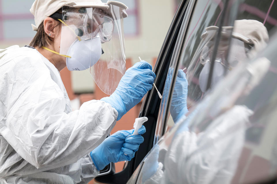 A medical worker administers a Covid-19 test at a testing site in Berkeley, California, U.S., on Friday, April 17, 2020. (David Paul Morris/Bloomberg via Getty Images)