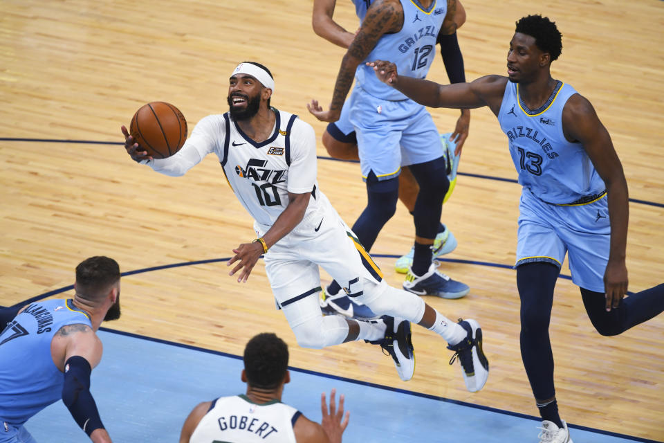 Utah Jazz guard Mike Conley (10) goes to the basket past Memphis Grizzlies forward Jaren Jackson Jr. (13) during the second half of Game 3 of an NBA basketball first-round playoff series Saturday, May 29, 2021, in Memphis, Tenn. Utah won 121-111. (AP Photo/John Amis)