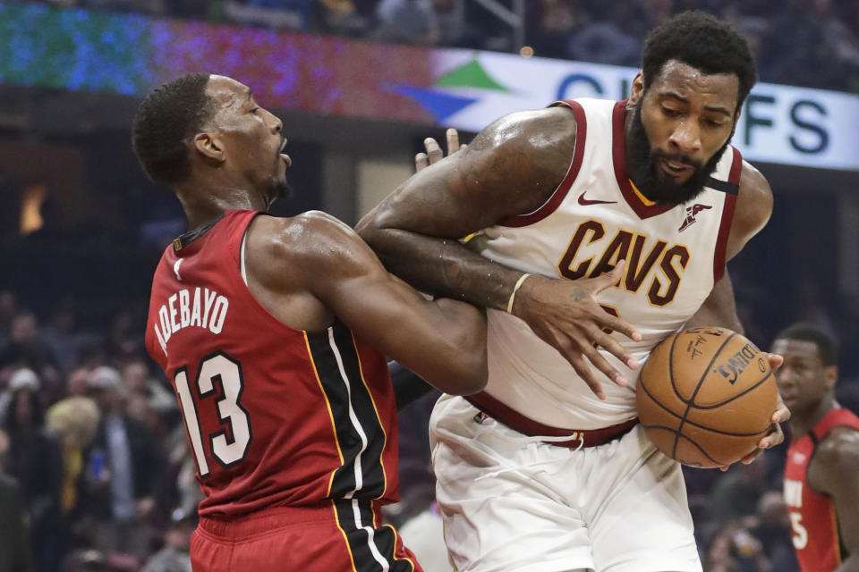 FILE - Cleveland Cavaliers' Andre Drummond, right, drives past Miami Heat's Bam Adebayo in the first half of an NBA basketball game, in Cleveland. On Friday, March 6, Drummond, Cavs guards Collin Sexton and Darius Garland, forwards Cedi Osman, Dante Exum and Dylan Windler, coach J.B. Bickerstaff, his entire staff and general manager Koby Altman, spent several hours visiting with offenders at Grafton _ a medium security prison housing 1,700 residents to share fellowship as well as some hope and hoops.(AP Photo/Tony Dejak)