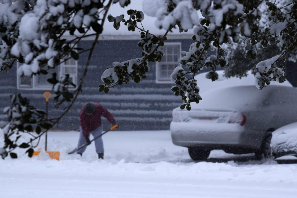 An industrious man out shoveling snow even as it continues to fall in Georgetown, around 9 a.m. Saturday.