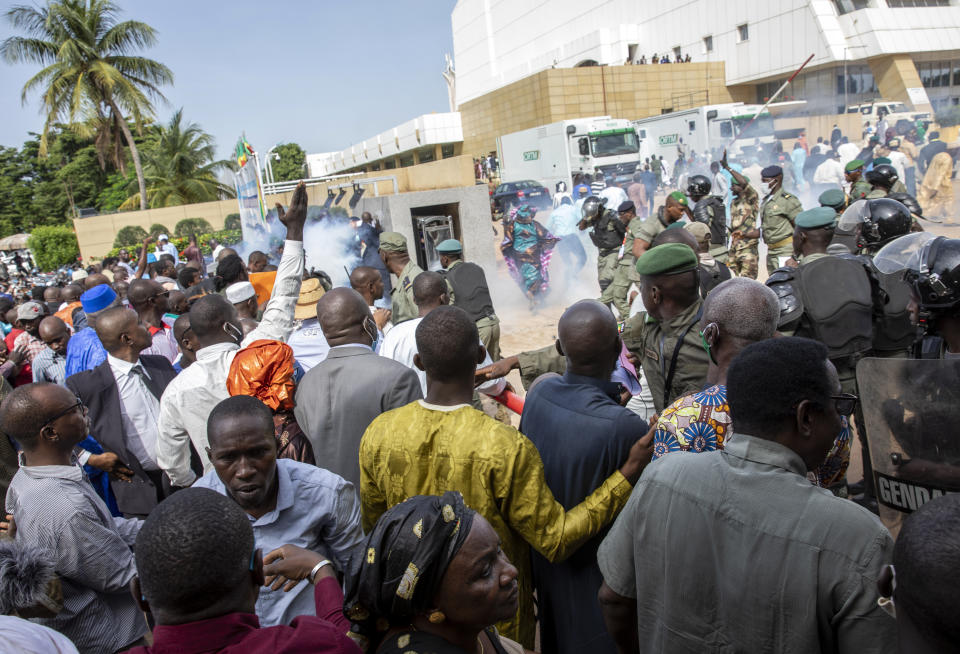 Security forces fire tear gas at people gathered outside a conference to discuss a transition to a civilian government in Bamako, Mali, Thursday, Sept. 10, 2020. Leaders of Mali's military junta who deposed the West African country's president last month are meeting with political parties and civil society groups to outline a transition to a civilian government and, ultimately, elections. (AP Photo)