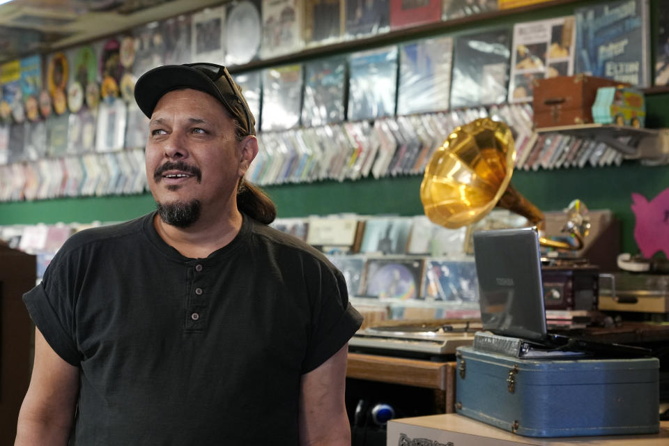 Tim Stamper, owner at Tracks In Wax record shop, pauses in his shop, Thursday, April 18, 2024, in Phoenix. Special LP releases, live performances and at least one giant block party are scheduled around the U.S. Saturday as hundreds of shops celebrate Record Store Day amid a surge of interest in vinyl and the day after the release of Taylor Swift's latest album. (AP Photo/Ross D. Franklin)