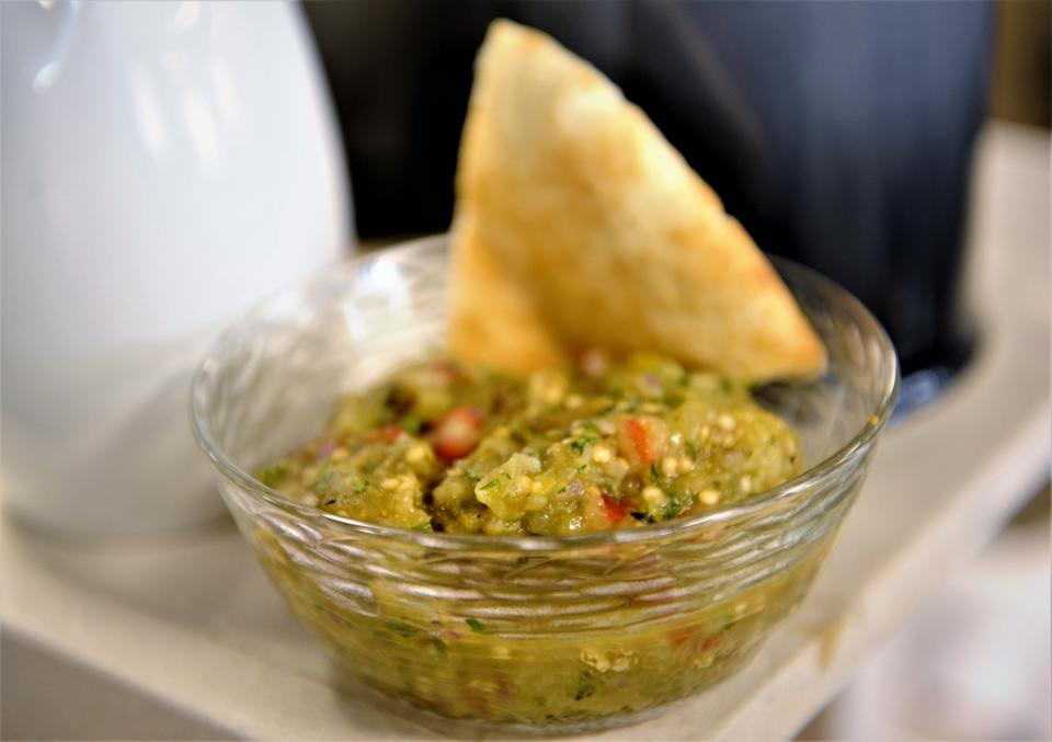 A French Riviera-style eggplant dip with fresh herbs, lemon, olive oil and diced tomato is served with pita bread for dipping.