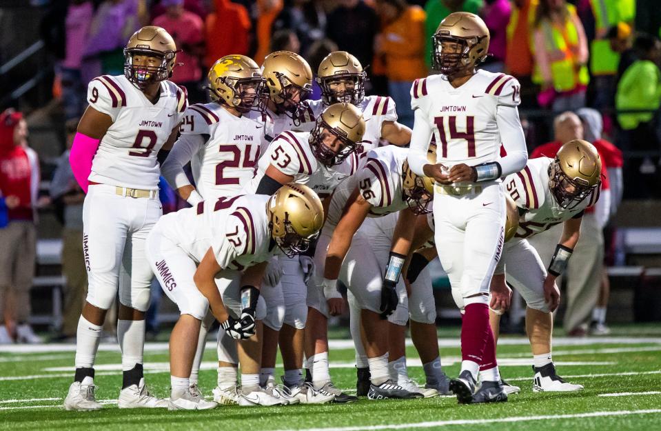 Jimtown players huddle up during the Adams vs. Jimtown football game Friday, Oct. 7, 2022 at School Field in South Bend.