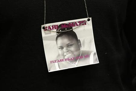 A photograph of 13-year-old Jahi McMath is seen on a necklace in Oakland, California December 24, 2013. REUTERS/Stephen Lam