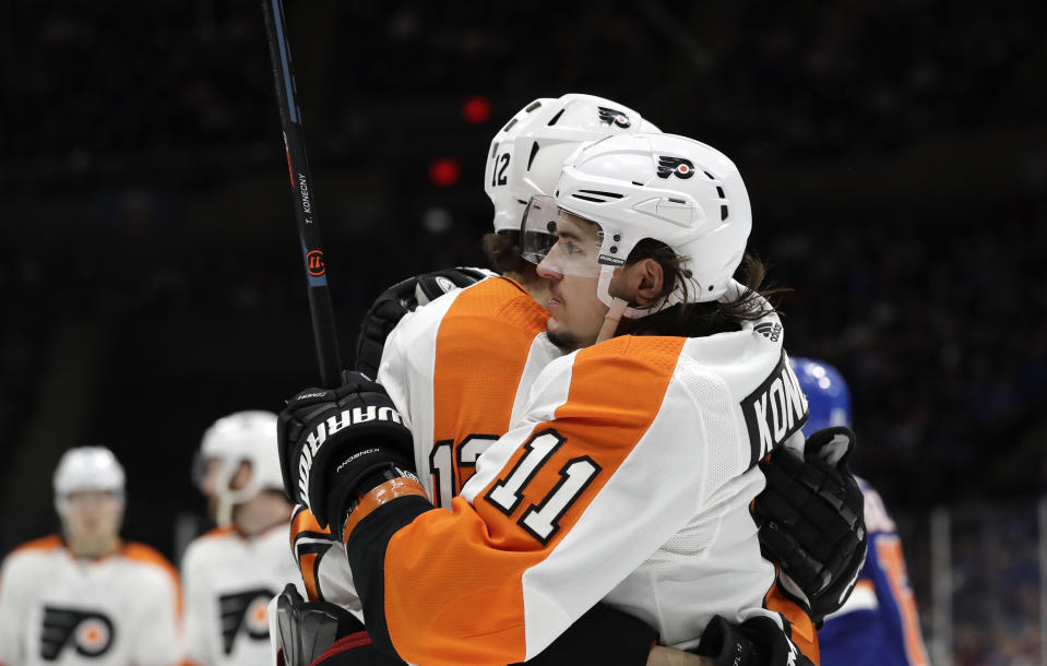 Philadelphia Flyers right wing Travis Konecy embraces left wing Michael Raffl (12) after scoring a goal during the first period of an NHL hockey game, Sunday, March 3, 2019, in Uniondale, N.Y. (AP Photo/Kathy Willens)