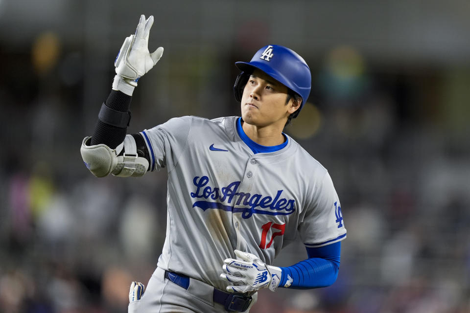 Los Angeles Dodgers designated hitter Shohei Ohtani celebrates as he runs the bases for his solo home run during the ninth inning of a baseball game against the Washington Nationals at Nationals Park, Tuesday, April 23, 2024, in Washington. The Dodgers won 4-1. (AP Photo/Alex Brandon)