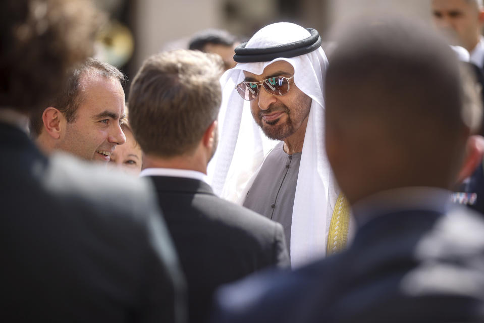 France's Defense Minister Sebastien Lecornu, left, welcome United Arab Emirates' President Sheikh Mohammed Bin Zayed, center during a welcome ceremony at the Invalides monument in Paris, Monday, July 18, 2022. United Arab Emirates' President Sheikh Mohammed Bin Zayed is for a two-days visit in France. (AP Photo/Thomas Padilla, Pool)