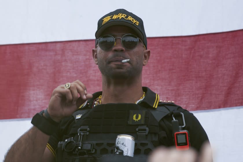 FILE - In this Sept. 26, 2020, file photo, Proud Boys leader Henry "Enrique" Tarrio wears a hat that says The War Boys during a rally in Portland, Ore. Police in the nation's capital on Jan. 4, 2021, arrested the leader of the Proud Boys, who is accused of burning a Black Lives Matter banner that was torn down from a historic Black church in downtown Washington in December 2020. (AP Photo/Allison Dinner, File)