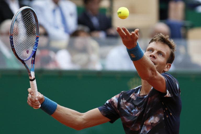 Czech player Tomas Berdych serves to Novak Djokovic at the Monte-Carlo ATP Masters final tennis match, on April 19, 2015 in Monaco