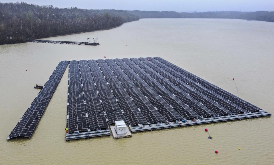 FILE - Solar panels are installed at a floating photovoltaic plant on a lake in Haltern, Germany, April 1, 2022. Floating solar panel farms are attractive not just for their clean power and lack of a land footprint, but because they also conserve water by preventing evaporation. (AP Photo/Martin Meissner, File)