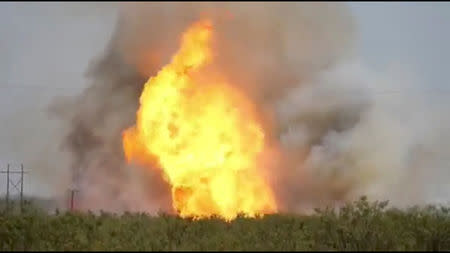 A pipeline explosion erupts in this image captured from video by a field worker in Midland County, the home to the Permian Basin and the largest U.S. oilfield, in Texas, U.S., August 1, 2018. Image taken on August 1, 2018. Courtesy Marty Baeza/Handout via REUTERS