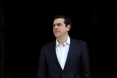 FILE PHOTO: Greek Prime Minister Alexis Tsipras waits to welcome his Maltese counterpart Joseph Muscat at the Maximos Mansion in Athens, Greece March 1, 2017. REUTERS/Alkis Konstantinidis/File Photo