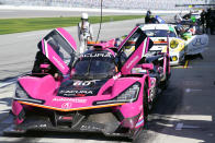 Cars line up on pit road, including the Meyer Stark Racing Acura DPi (60) before a practice session for the Rolex 24 hour race at Daytona International Speedway, Friday, Jan. 29, 2021, in Daytona Beach, Fla. (AP Photo/John Raoux)