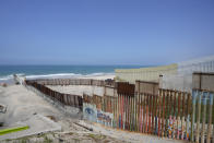 Construction continues on the border wall that separate the United States from Mexico, as seen from Tijuana, Mexico, Friday, Aug. 25, 2023. As the U.S. government built its latest stretch of border wall, Mexico made a statement of its own by laying remains of the Berlin Wall a few steps away. (AP Photo/Gregory Bull)