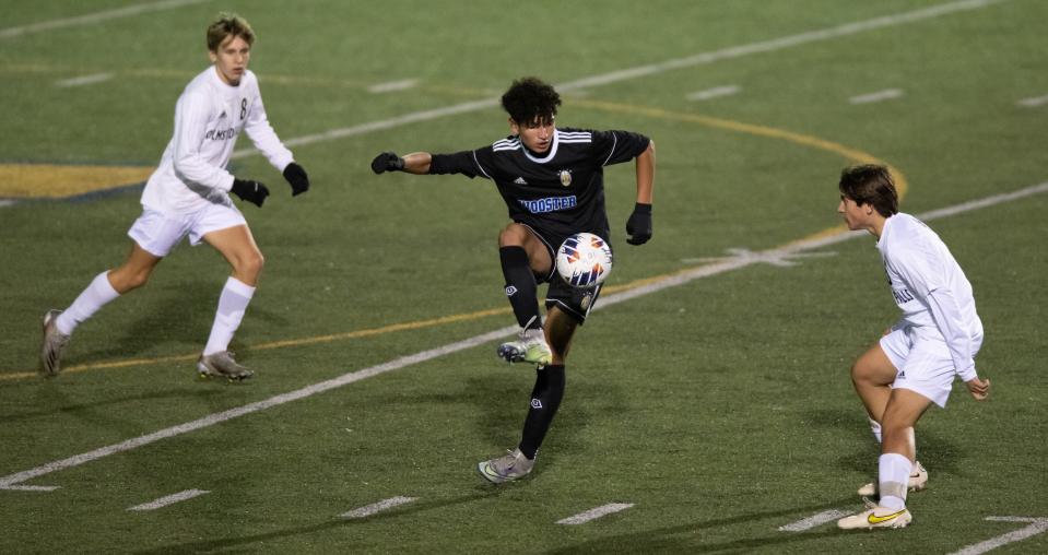 Wooster's Luigi Canas Jr. controls the ball near midfield.