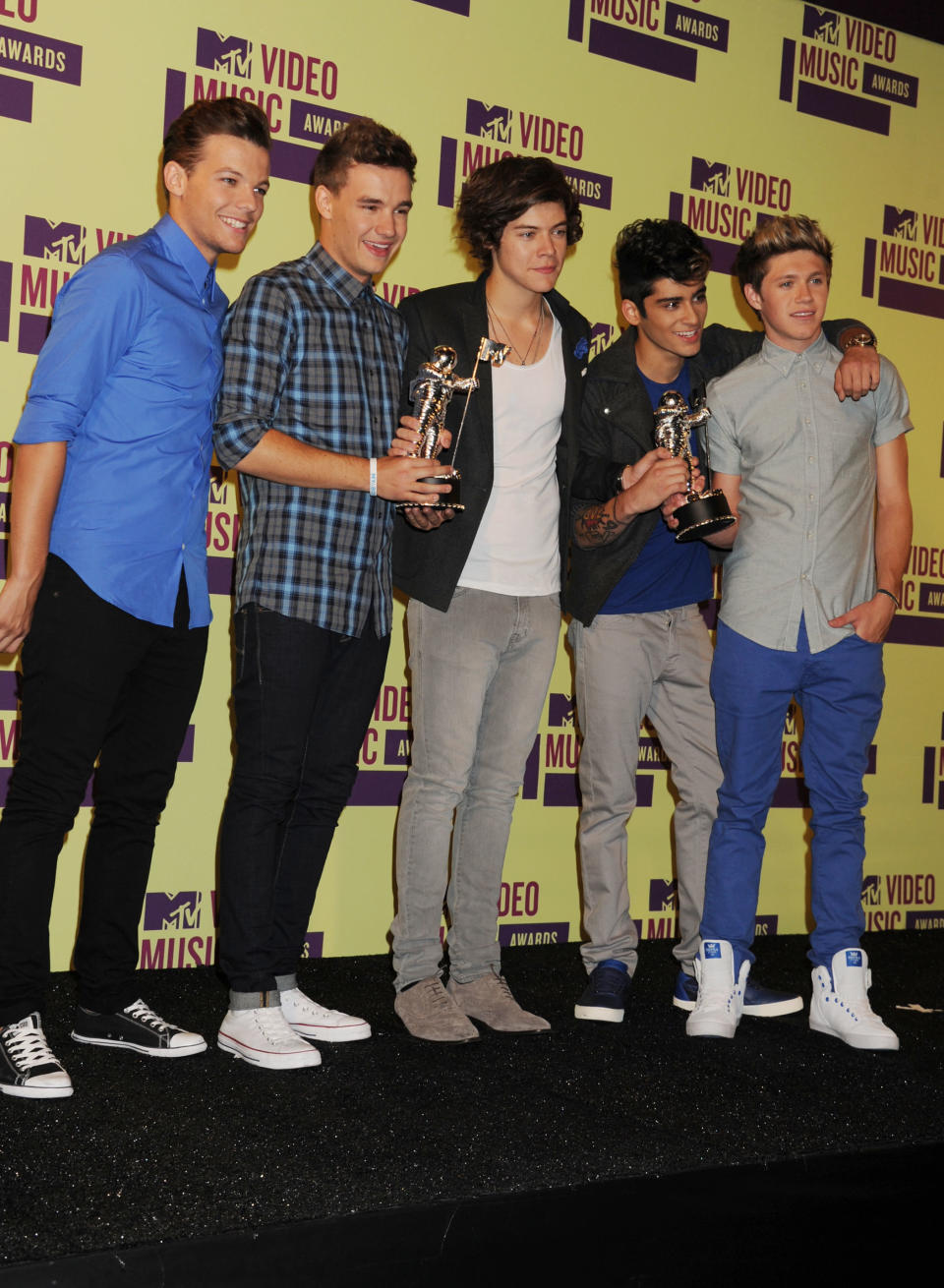 One Direction posing for photos backstage with their VMAs