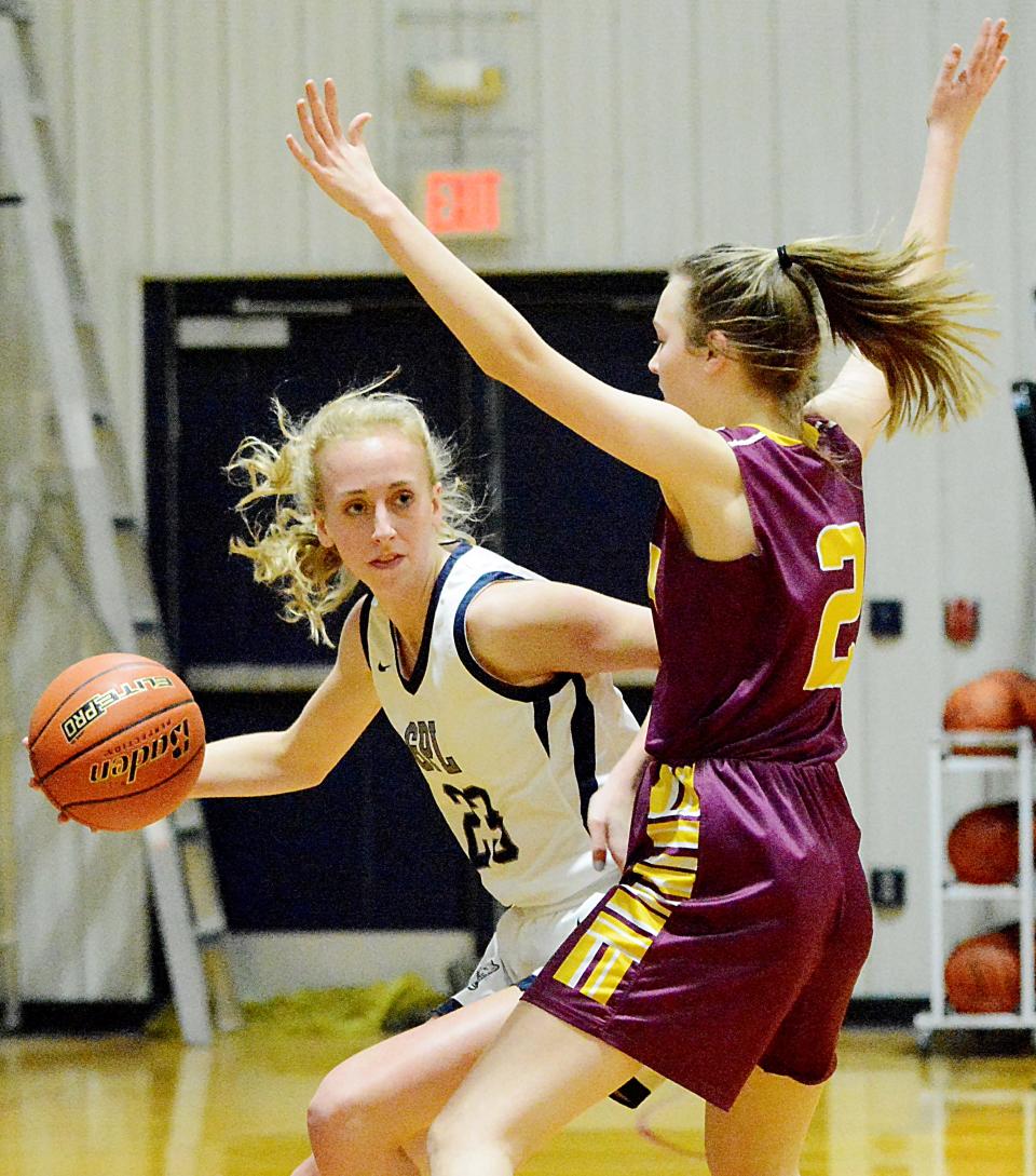Great Plains Lutheran's Bryn Holmen (23) makes a move to the basket against Langford Area's Bryanna Peterson during their opening-round game in the 2021 Region 1B girls basketball tournament in Watertown.