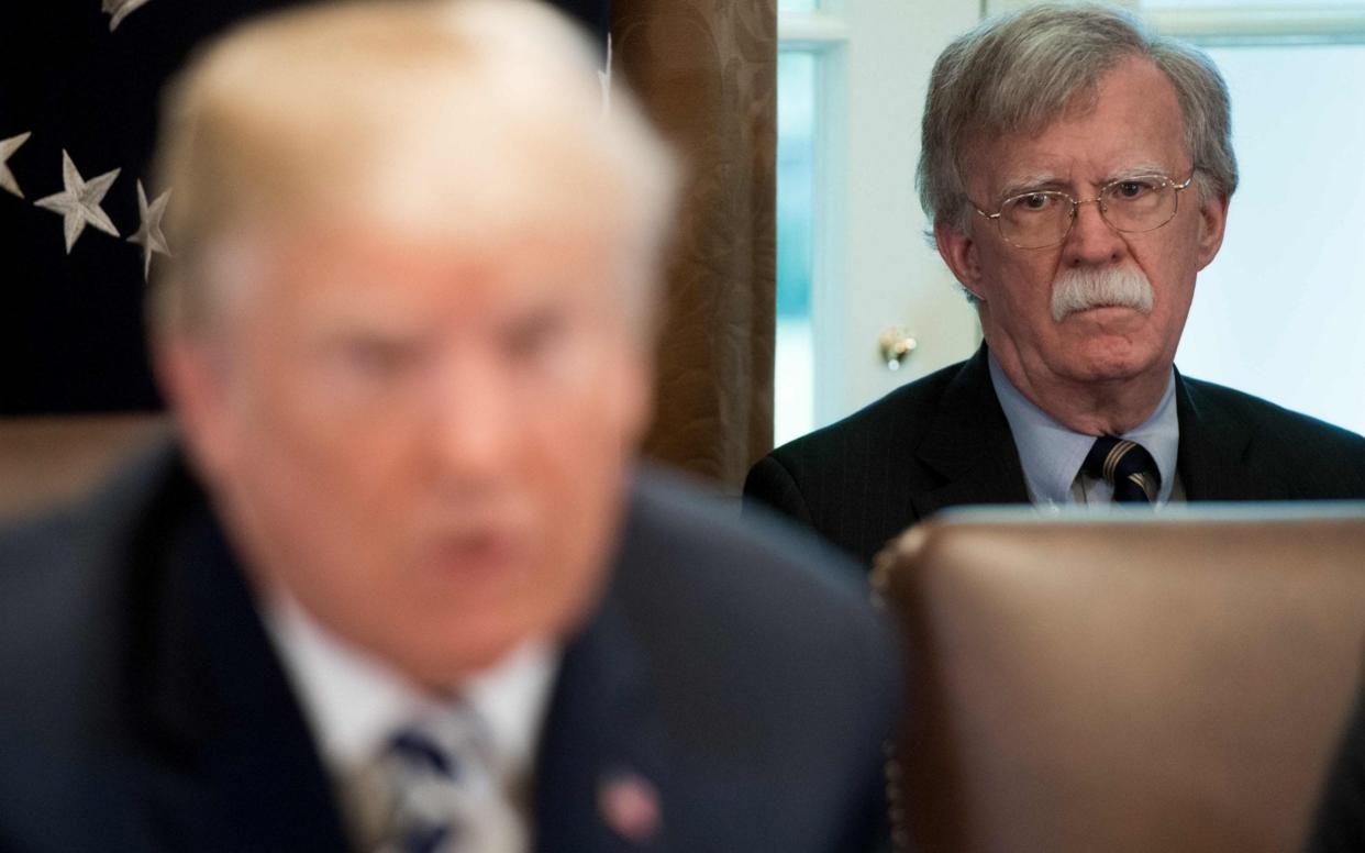 US President Donald Trump speaks alongside National Security Advisor John Bolton in 2018 - SAUL LOEB /AFP