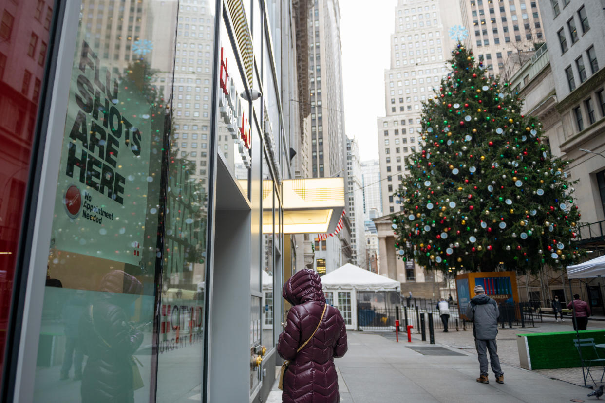 NEW YORK, NEW YORK - DECEMBER 02: A "Flu shots are here" sign is displayed in the window of a CityMD near a large Christmas Tree displayed in front of the New York Stock Exchange on December 02, 2020 in New York City. (Photo by Alexi Rosenfeld/Getty Images)