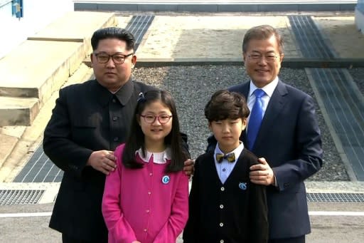 North Korea's leader Kim Jong Un and South Korea's President Moon Jae-in (R) stand with children as they meet at the Military Demarcation Line that divides their countries at Panmunjom