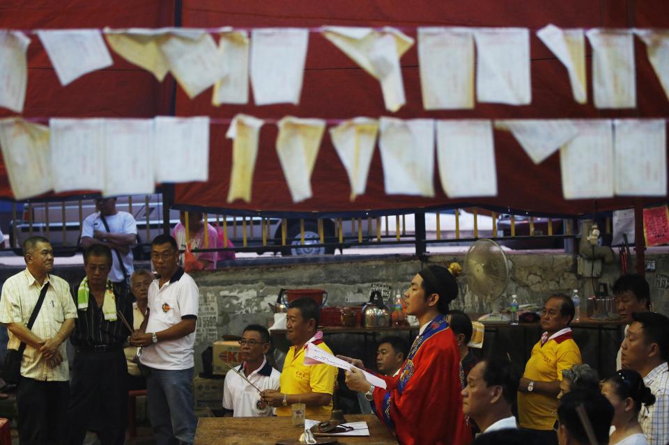 A monk leads prayers during the Hungry Ghost festival in Kuala Lumpur