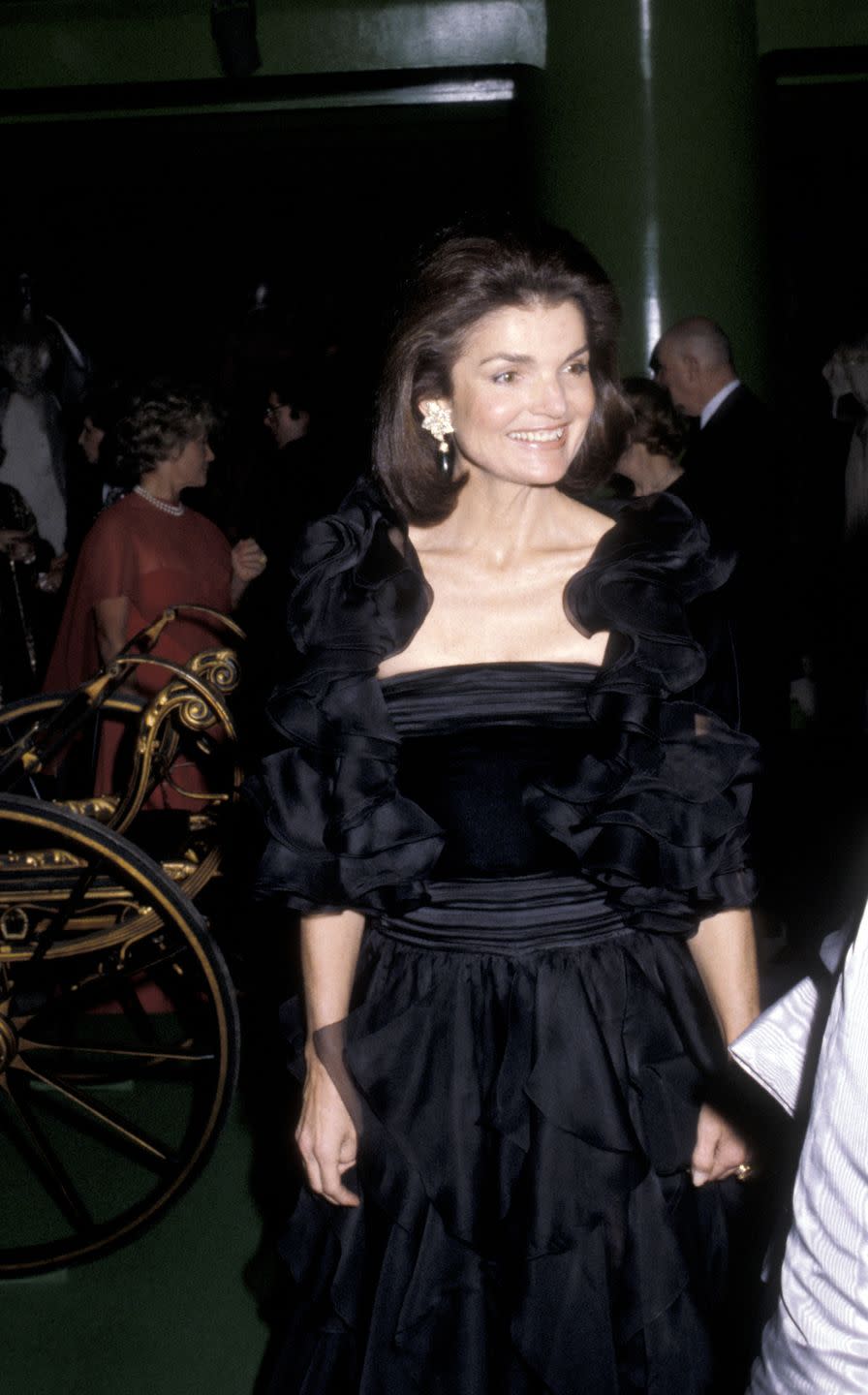 <p>Jackie attends the Costume Institute Gala at the Metropolitan Museum of Art in New York wearing a velvet and chiffon black evening gown with oversize statement earrings. </p>