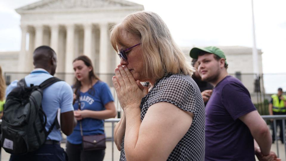 A pro-life supporter reacts outside the US Supreme Court in Washington, DC, on June 24, 2022. - The US Supreme Court on Friday ended the right to abortion in a seismic ruling that shreds half a century of constitutional protections on one of the most divisive and bitterly fought issues in American political life. The conservative-dominated court overturned the landmark 1973 