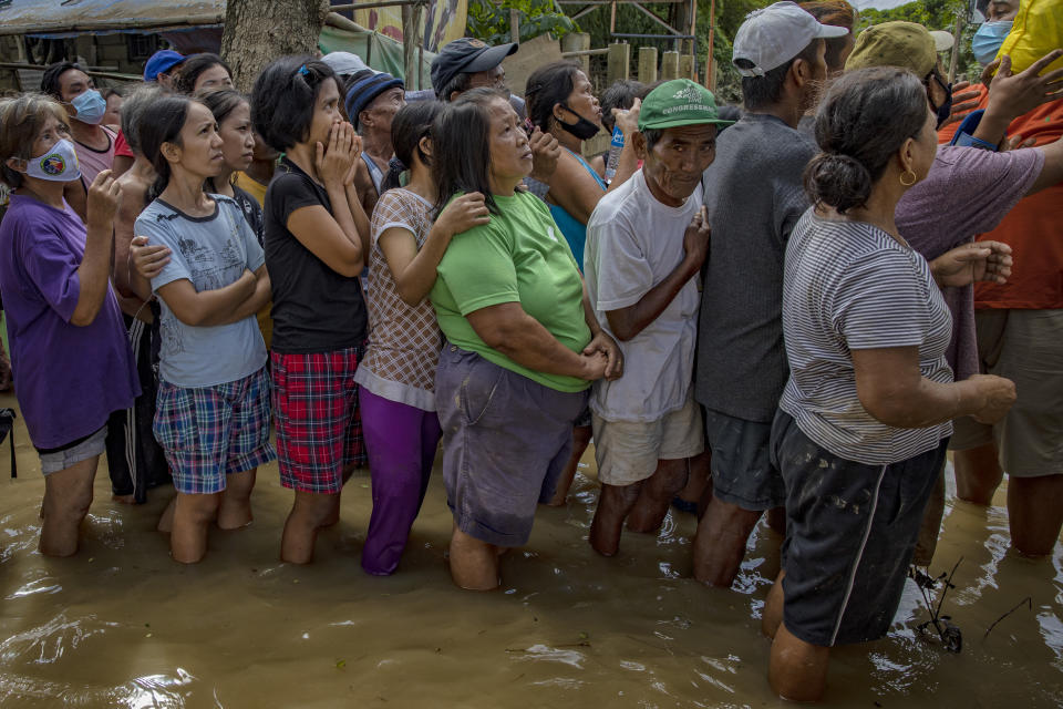 TUGUEGARAO, PHILIPPINES - NOVEMBER 16: Residents affected by Typhoon Vamco queue in floodwaters to receive relief goods on November 16, 2020 in Tuguegarao, Cagayan province, Philippines. The Cagayan Valley region in northern Philippines saw its worst flooding in 48 years after a dam released massive amounts of rainwater brought about by Typhoon Vamco. The country continues to reel from the widespread destruction caused by this year's deadliest cyclone which has killed at least 67 people. (Photo by Ezra Acayan/Getty Images)