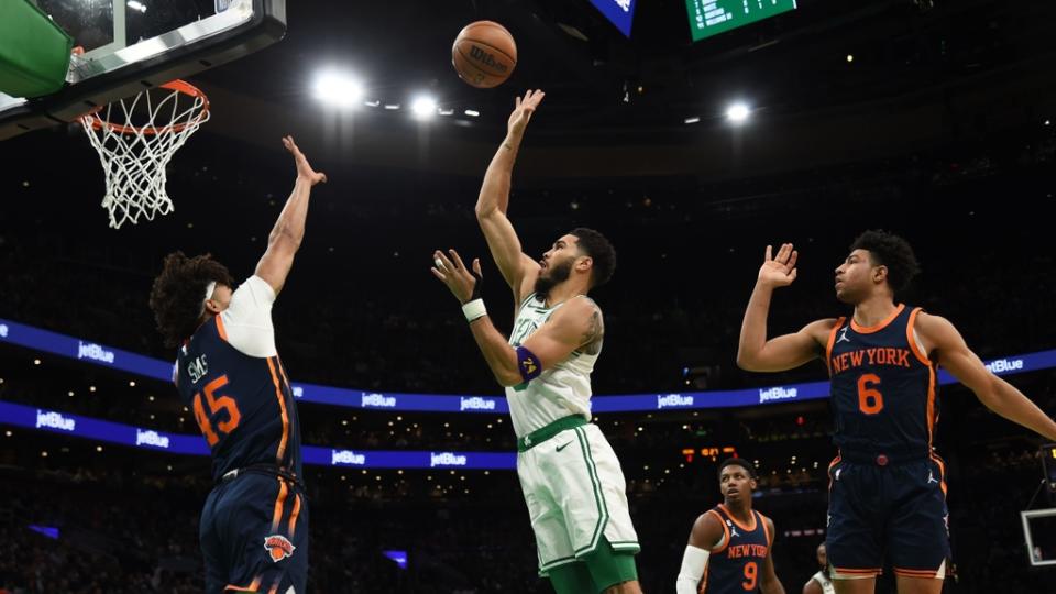 Jan 26, 2023; Boston, Massachusetts, USA; Boston Celtics forward Jayson Tatum (0) shoots the ball over New York Knicks center Jericho Sims (45) during the first half at TD Garden. Mandatory Credit: Bob DeChiara-USA TODAY Sports