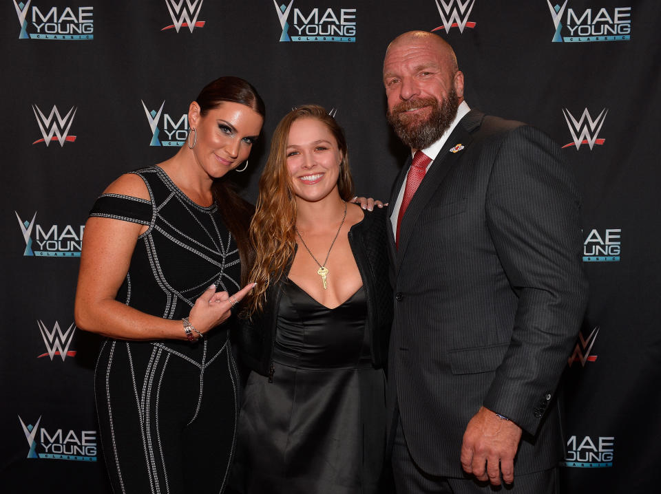 Ronda Rousey will stand opposite Triple H and Stephanie McMahon (also pictured) inside the ring at Wrestlemania 34 (Getty)