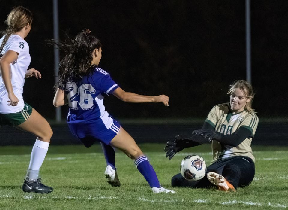 GlenOak goalie Sydney Meyer stops the shot of Jackson’s Raquel Maghes during Monday's Division I district semifinal girls soccer game.